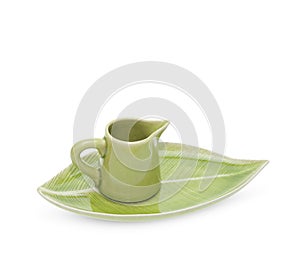 Green teapot with saucer isolated on white background