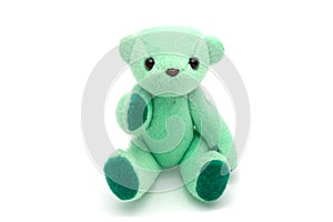 Green teddy bear sitting on white background