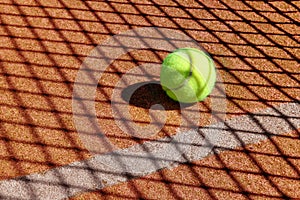 Green tennis ball on an outdoor court