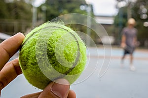 A green tennis ball on a sunnyday