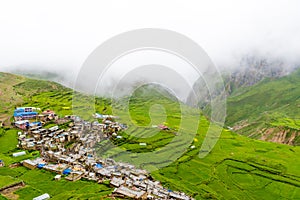 Green terraced fields and traditional architecture in the ancient Tibetan Nar village