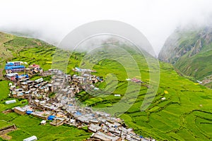 Green terraced fields and traditional architecture in the ancient Tibetan Nar village