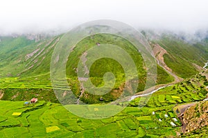 Green terraced fields and traditional architecture in the ancient Tibetan Nar village, Annapurna Conservation Area, Nepal