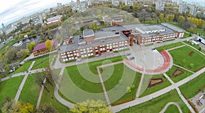 Green territory near brick building, view from