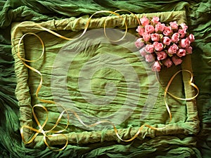 Green textile frame with rose heart