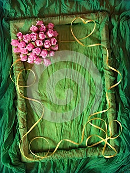 Green textile frame with rose heart