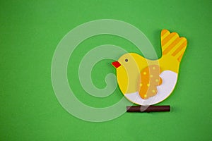 Green texture with wooden Easter chicken, conceptual photo