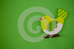 Green texture with wooden Easter chicken, conceptual photo