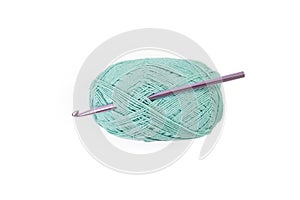 green thread spool with purple crochet hook