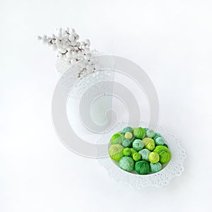 Green threads in a white basket on a white background.