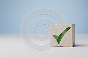 Green tick. Goals achievement and business success. Task completion. Ethical corporate. Do right thing. Quality symbol. Wooden