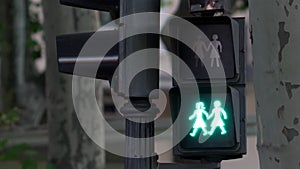 Green to red traffic LED light for pedestrians symbolizing a lesbian girls couple in a street of Madrid