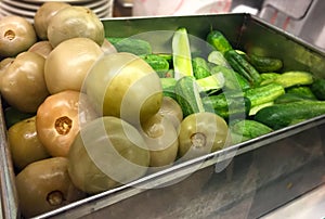 Green Tomatoes and Cucumber pickles close up