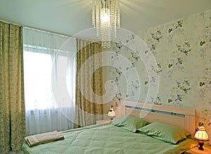 Green-toned bedroom with table lamps