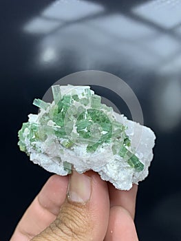 Green tourmaline bunch cluster with matrix mineral specimen from Afghanistan photo
