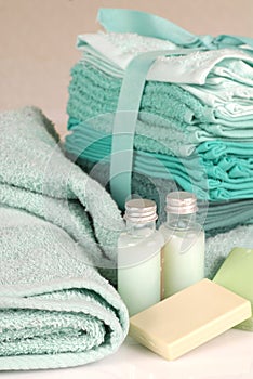 Green towels with soap and shampoo