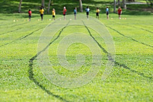 Green Track and Field running Track with children in the background