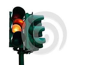 Green traffic light with burning yellow lamp