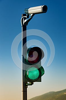 Green on traffic light with security camera