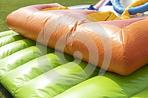 Green trampoline. Inflatable slide. Obstacle course. Entertainment in park