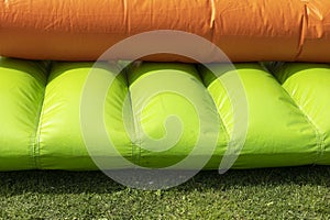 Green trampoline. Inflatable slide. Obstacle course. Entertainment in park