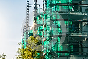 Green Translucent Covered Scaffolding Building Project Sunset