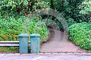 Green trashcan for keeping garbage in public park