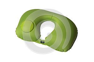 Green travel neck pillow with air valve isolated on white