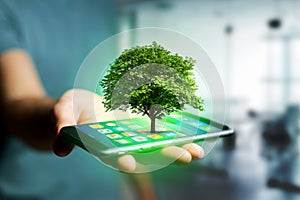 Green tree going out of a smartphone - Ecology concept