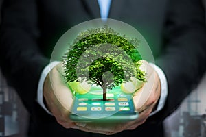 Green tree going out of a smartphone - Ecology concept