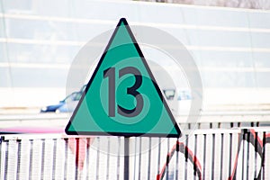 Green triangle sign along railroad indicating the speed 13 means 130 kilometers hour for the train in the Netherlands,