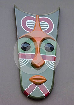 Green tribal mask on wall