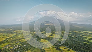 Green tropic farmlands at volcano hillside valley aerial. Legazpi town at tropical Philippine island