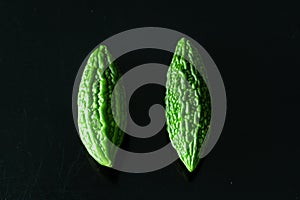 Green tropical momordica charantia or Chinese bitter gourd on black background