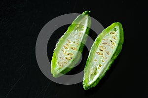 Green tropical momordica charantia or Chinese bitter gourd on black background