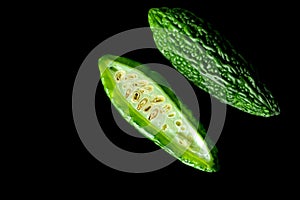 Green tropical momordica charantia or Chinese bitter gourd on black background