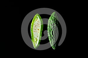Green tropical momordica charantia or Chinese bitter gourd on black background