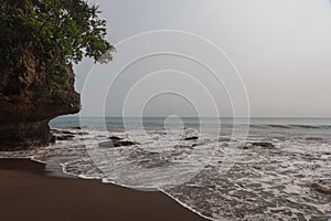 Green tropical mountains and ocean waves