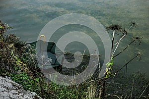 Green umbrella floating in the river