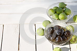 Green fig jam bowl on white wooden table