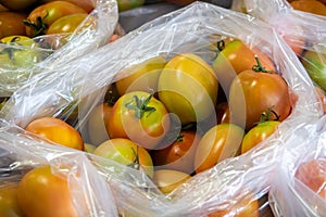 Green unripe tomatoes, mixed green and red orangeà¸¡ put in plastic bags divided into sales