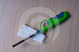 Green Utility Lighter and Firelighter Brick on Wooden Surface