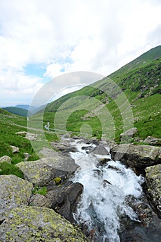 Green valley crossed by mountain creek