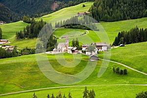 Green valley in Dolomite alps with a small village