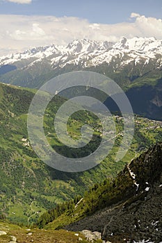 Green valley with houses and mountains