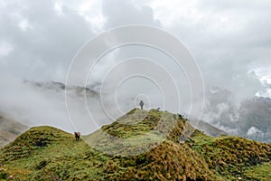 Green valley surrounded by mountains in clouds, Choquequirao trek between Yanama and Totora, Peru