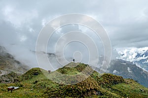 Green valley surrounded by mountains in clouds, Choquequirao trek between Yanama and Totora, Peru