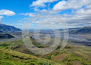 Green valley of Thorsmork, with volcanoes, glaciers, green forest and blue sunny sky in summer day, Highlands of Iceland, Europe