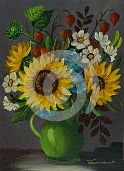 A green vase with different coloured flowers