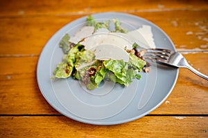 Green vegetable salad with parmesan cheese toppings in a plate